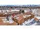 Aerial view of condo building in snowy landscape with mountain backdrop at 3305 S Ammons St # 202, Lakewood, CO 80227