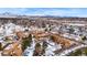 Aerial view of a neighborhood with diverse housing, mature trees, and views of distant mountains at 3305 S Ammons St # 202, Lakewood, CO 80227