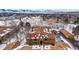 Aerial view of condo building in snowy landscape with mountain backdrop at 3305 S Ammons St # 202, Lakewood, CO 80227