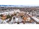 Aerial view highlighting the community layout with apartments, snow-covered landscape, and scenic mountain range at 3305 S Ammons St # 202, Lakewood, CO 80227