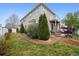 Spacious backyard with a patio, lush lawn, and mature trees at 5293 Malaya St, Denver, CO 80249
