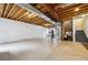 Unfinished basement with exposed ceiling, concrete floor and mechanical equipment at 5293 Malaya St, Denver, CO 80249