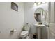 Cozy half bathroom featuring a pedestal sink and decorative accents at 5293 Malaya St, Denver, CO 80249