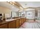Large bathroom with double sinks, soaking tub, and glass enclosed shower at 5293 Malaya St, Denver, CO 80249