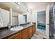 Bathroom featuring double sinks and shower with blue shower curtain at 5293 Malaya St, Denver, CO 80249