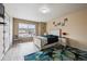 Bright bedroom featuring a decorative rug, a large window and light hardwood floors at 5293 Malaya St, Denver, CO 80249