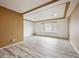 A spacious bedroom bathed in natural light with wood look flooring and tray ceiling at 5293 Malaya St, Denver, CO 80249