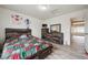 Cozy bedroom featuring a dark wood frame bed and laminate flooring at 5293 Malaya St, Denver, CO 80249