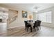 Bright dining room with stylish chandelier, wood flooring and staircase access at 5293 Malaya St, Denver, CO 80249
