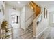 Foyer showcasing wood flooring, a staircase with glass accents, and ample natural light at 5293 Malaya St, Denver, CO 80249