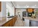Kitchen features stainless steel appliances, long countertops, and wood cabinetry for a modern feel at 5293 Malaya St, Denver, CO 80249