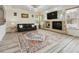 Bright living room featuring a fireplace, large windows, and stylish furnishings at 5293 Malaya St, Denver, CO 80249