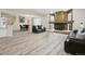 Open concept living room featuring a fireplace and wood-look flooring at 5293 Malaya St, Denver, CO 80249