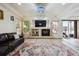 An elegant living room features a fireplace, large windows, and sliding door access to the exterior at 5293 Malaya St, Denver, CO 80249