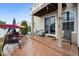 Covered patio with swing, seating, and sliding glass door, perfect for relaxing outdoors at 5293 Malaya St, Denver, CO 80249