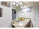 Bathroom featuring double sinks, granite countertops, and ample lighting at 8321 E 33Rd Ave, Denver, CO 80238