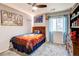 This bedroom has a large bed and a ceiling fan at 8321 E 33Rd Ave, Denver, CO 80238