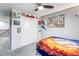 The bedroom has sports-themed decor and a ceiling fan at 8321 E 33Rd Ave, Denver, CO 80238