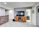 Bonus room featuring a television and a doorway leading to an ensuite bathroom at 8321 E 33Rd Ave, Denver, CO 80238