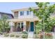Charming townhome featuring a covered porch, brick accents, and freshly landscaped front yard at 8321 E 33Rd Ave, Denver, CO 80238