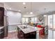 Bright, open kitchen with a granite island that looks out into the living and dining areas at 8321 E 33Rd Ave, Denver, CO 80238