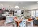 Open floor plan featuring a modern kitchen with granite countertops flowing into the living room at 8321 E 33Rd Ave, Denver, CO 80238
