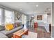 Open-concept living space featuring a comfortable sofa and a view into the dining area and kitchen at 8321 E 33Rd Ave, Denver, CO 80238
