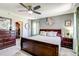 The primary bedroom has a large bed, dark wood furniture, and a walk-in closet at 8321 E 33Rd Ave, Denver, CO 80238