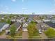 Aerial view of a neighborhood with a mix of home styles and mature trees at 4436 Windmill Dr, Brighton, CO 80601