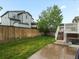 Fenced backyard with grass, small deck and mature trees, perfect for outdoor entertaining at 4436 Windmill Dr, Brighton, CO 80601