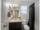 Well-lit bathroom features a black vanity with one sink and a shower with a black shower curtain at 4436 Windmill Dr, Brighton, CO 80601