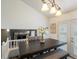 Stylish dining room with a contemporary chandelier, a dark wood table, and open views of the living space at 4436 Windmill Dr, Brighton, CO 80601