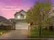 Inviting two-story home with a well-manicured lawn, two-car garage, and a basketball hoop on the driveway at 4436 Windmill Dr, Brighton, CO 80601