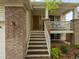 Welcoming front porch with steps leading up to the home, complemented by brick and siding at 4436 Windmill Dr, Brighton, CO 80601