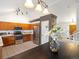 Open kitchen with stainless steel appliances, tile flooring, and a view into the dining area at 4436 Windmill Dr, Brighton, CO 80601