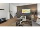 Comfortable living area with modern decor, leading to a staircase and adjacent dining space at 4436 Windmill Dr, Brighton, CO 80601