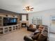 Inviting living room with a cozy fireplace and entertainment center with a comfortable sectional sofa at 4436 Windmill Dr, Brighton, CO 80601