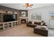 Comfortable living room featuring a fireplace, large TV, and a cozy sectional sofa at 4436 Windmill Dr, Brighton, CO 80601