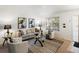 Bright living room with a comfortable sofa, complementary armchairs, and trendy black and white carpet at 4436 Windmill Dr, Brighton, CO 80601