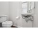 Small bathroom featuring modern sink, sleek plumbing fixtures and a white toilet, designed for functionality and style at 1711 Hooker St # 2, Denver, CO 80204