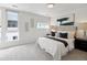 Bright bedroom with windows, neutral walls, plush carpeting, and stylish decor providing a peaceful space at 1711 Hooker St # 2, Denver, CO 80204