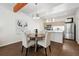 Elegant dining area with a round table, stylish chairs, and an open view to the kitchen at 1711 Hooker St # 2, Denver, CO 80204