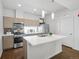 Modern kitchen showcasing stainless steel appliances, island with sink, and sleek cabinetry at 1711 Hooker St # 2, Denver, CO 80204