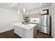 Stylish kitchen features stainless steel appliances, a central island, and ample natural light at 1711 Hooker St # 2, Denver, CO 80204