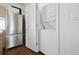 A stackable washer and dryer are conveniently placed in this laundry area, next to the stainless steel refrigerator at 1711 Hooker St # 2, Denver, CO 80204