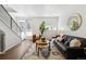 Inviting living room with a modern staircase, large windows, and a sleek black sofa at 1711 Hooker St # 2, Denver, CO 80204