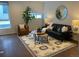 Stylish living room boasts a black leather sofa, area rug, and decor, creating a comfortable and inviting space at 1711 Hooker St # 2, Denver, CO 80204