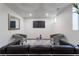 Cozy basement is staged with neutral walls, track lighting, modern furniture, and plank flooring at 3105 N Elizabeth St, Denver, CO 80205