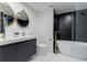 Stylish bathroom featuring black subway tile accent wall and modern fixtures at 3105 N Elizabeth St, Denver, CO 80205