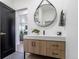 Bathroom featuring vanity with quartz countertops, round mirror, and designer fixtures at 3105 N Elizabeth St, Denver, CO 80205